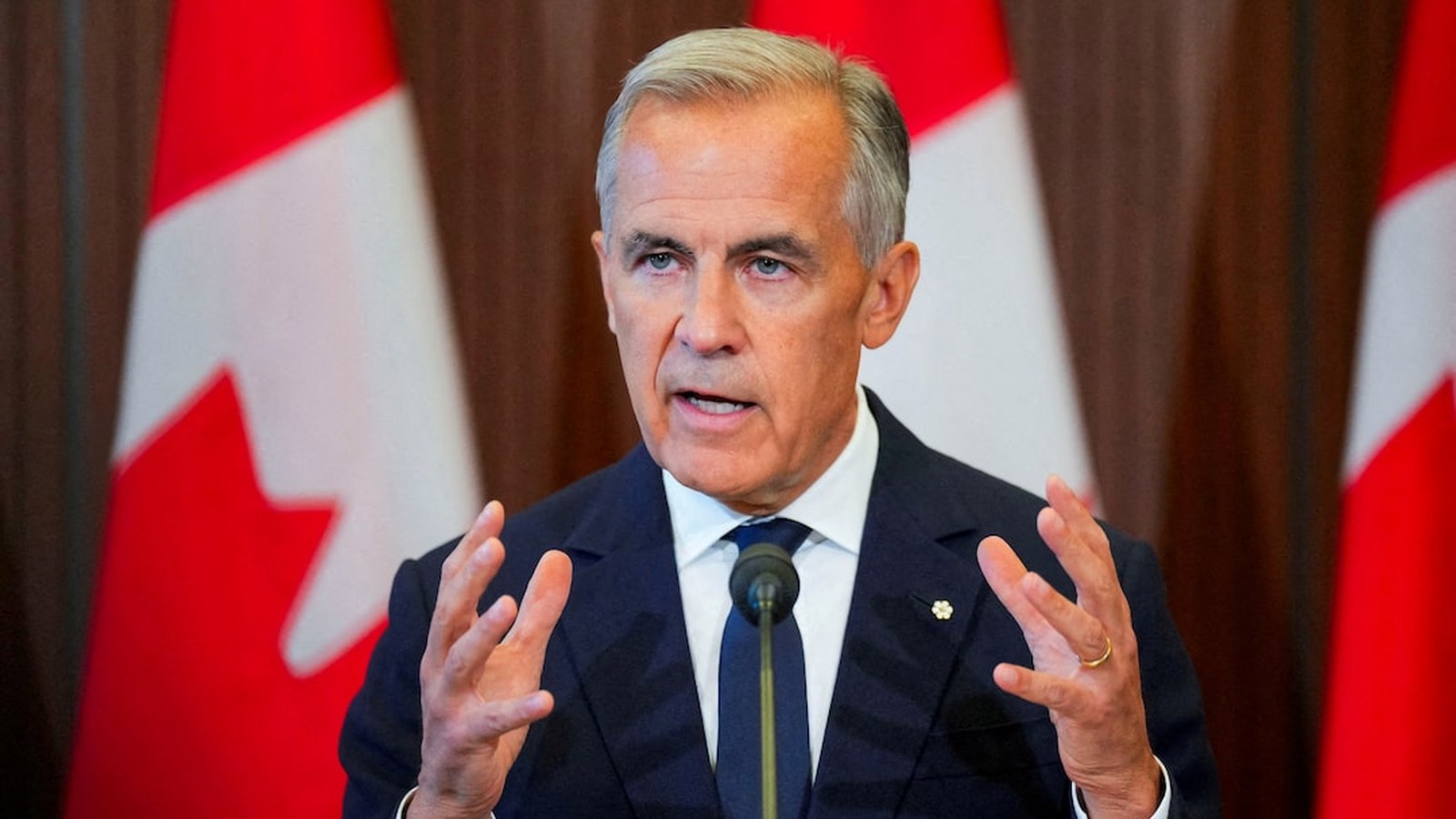 Podium still from 8 September 2026 on the U.S.–Canada trade file. Reuters photograph, not an AI scene.