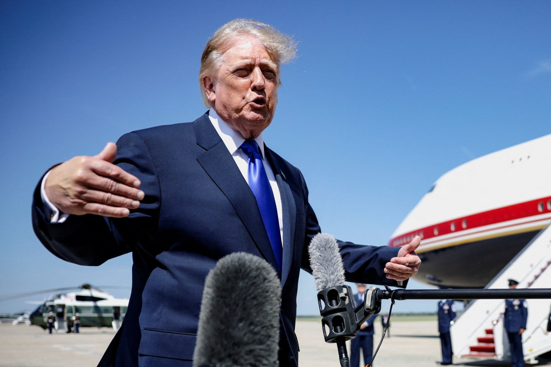 President Trump speaks to reporters at Joint Base Andrews, 9 Sep 2026, Marine One and Air Force One visible behind, before Dallas midterm-convention flight.